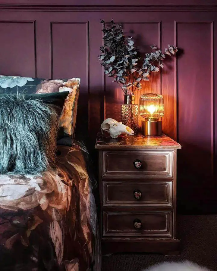 Dark burgundy paneled bedroom from @mrsgregsie. Warm lighting and textured bedding create cozy atmosphere.