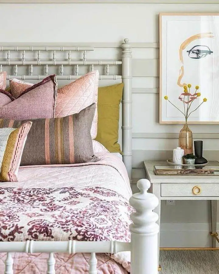White iron bed frame with layered pink bedding from @modernhistoryfurniture. Perfect grown woman bedroom ideas inspiration with romantic styling.