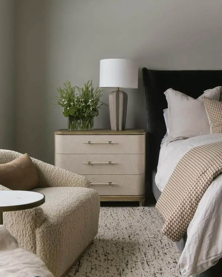 Sophisticated bedroom featuring forest green upholstered headboard from @gatehouseno1. Neutral tones and natural textures create elegant contrast.