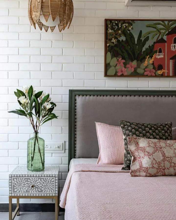 Tropical botanical artwork from @attirail.in. Features vibrant greens and coral florals in wooden frame above upholstered bed.