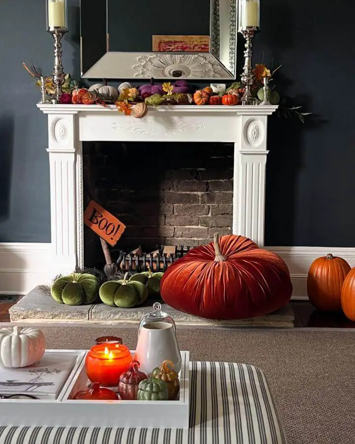 Burgundy velvet pumpkin and mixed halloween fireplace decor ideas from @myvictoriantownhouse. Traditional white mantel with autumn styling.