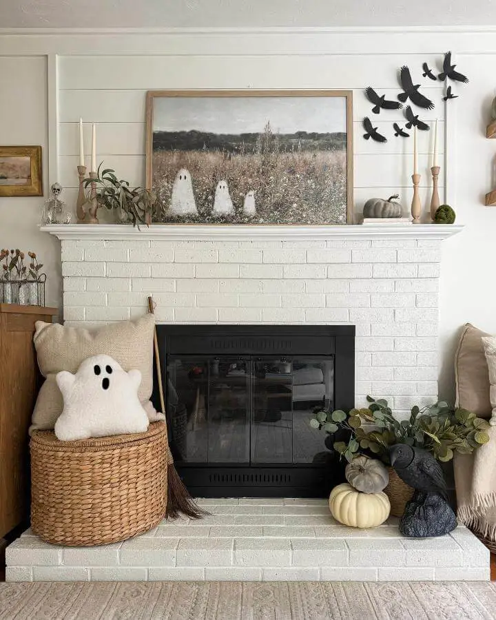 Black paper crows arranged above white brick fireplace mantel from @lwdecor. Spooky birds contrast against neutral autumn decor.