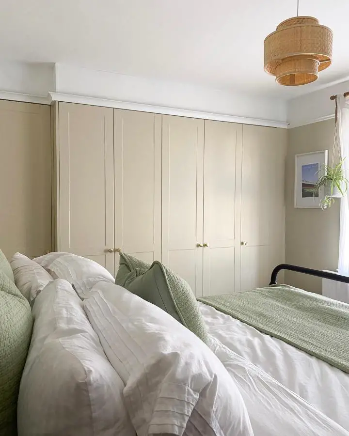 Cream built-in wardrobes from @megbrackpool. Crown molding creates seamless custom storage solution.