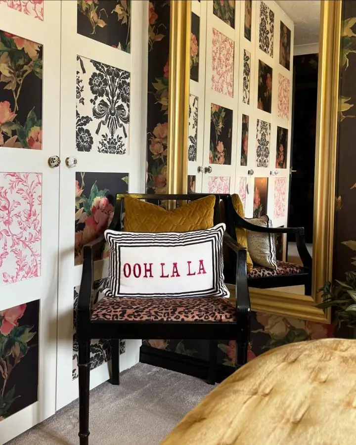 Floral wallpaper backdrop with white Pax wardrobe displaying framed fabric samples showcasing ikea bedroom hacks from @_athomewithnat.