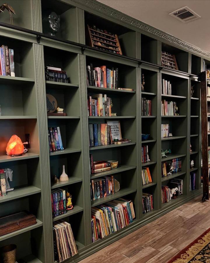 dark green traditional styled wall bookshelves from @the.sarah.will. Classic molding details with rich olive paint finish ikea billy bookcase hacks & ideas