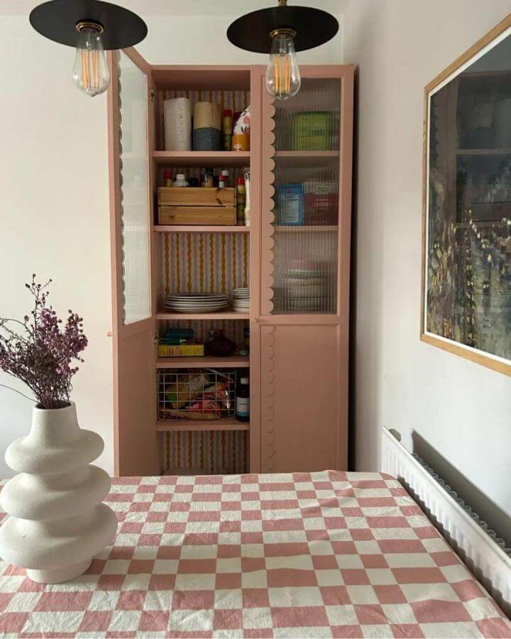 Soft pink scalloped edge ikea billy bookcase hacks & ideas pantry with ribbed glass doors from @thehousewiththepinkbed. Vintage-inspired kitchen storage solution.