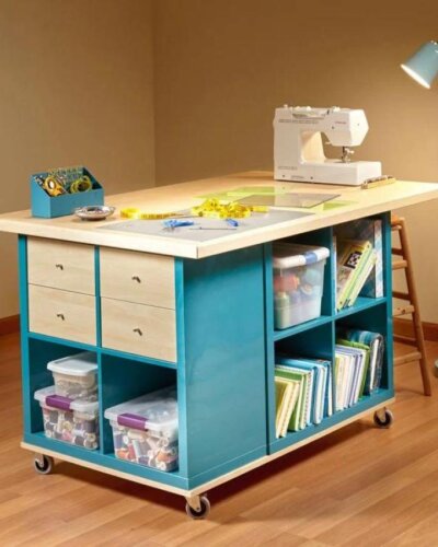 Teal and light wood rolling craft table from @sewingwithmarte with drawers and cubbies for ikea craft table hacks organization.
