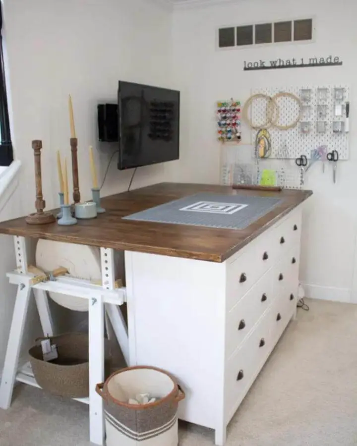 Warm stained wood top craft table with white storage drawers from @thebarnoncloverfarm showing ikea craft table hacks and organized crafting space.