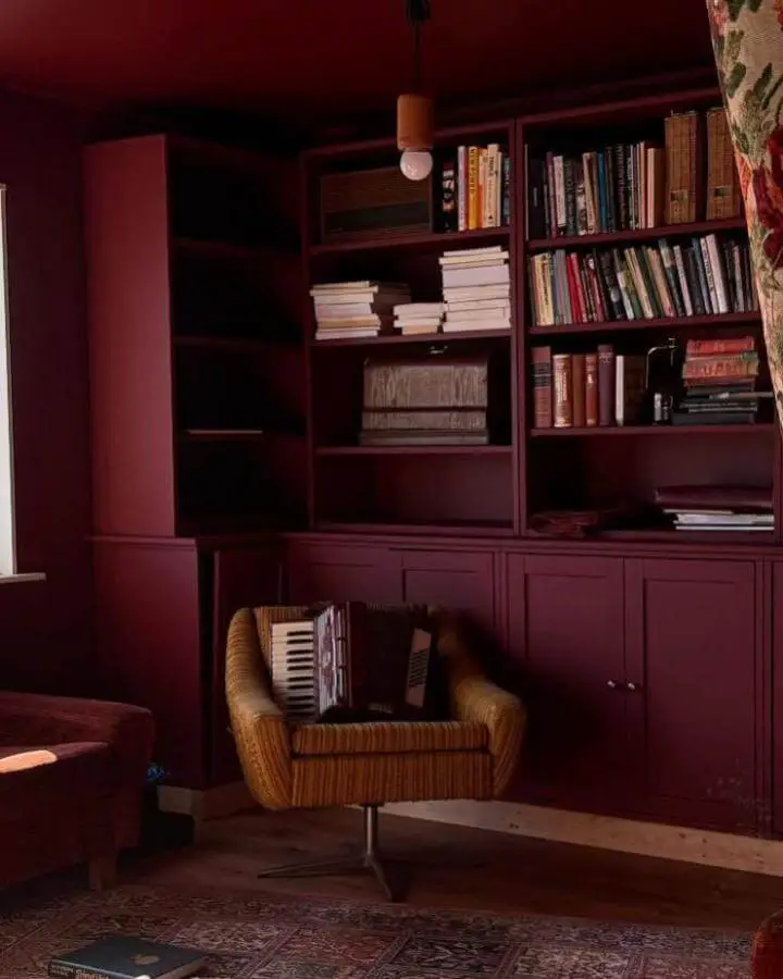 Burgundy painted storage unit from @husetimollegata featuring ikea havsta hacks & ideas with book display and cabinet doors.