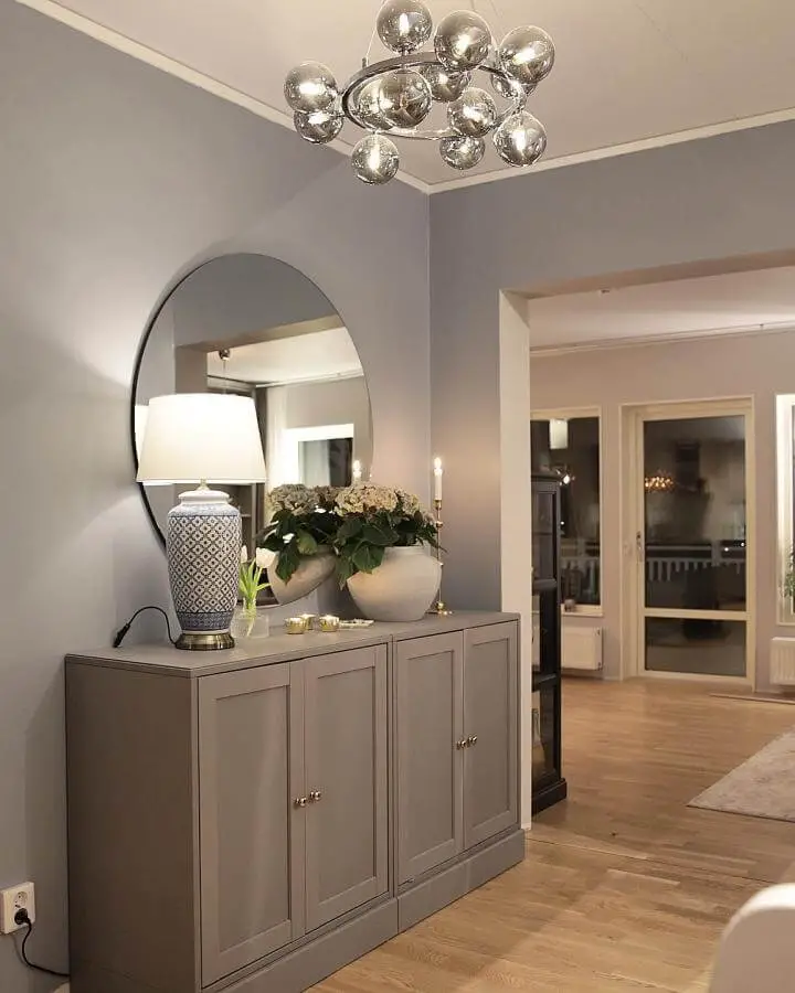 Gray painted Havsta cabinet from @angelicas.hem. Entryway styling with round mirror and decorative lamp.