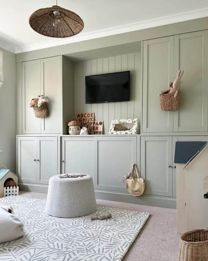 Sage green playroom storage wall showcasing ikea havsta hacks & ideas from @byhannahjones. Floor-to-ceiling cabinets with paneling detail