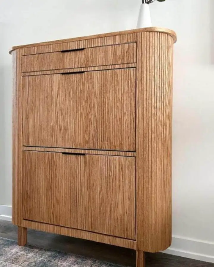 Natural wood veneer Ikea hemnes hacks cabinet with black handles and rounded edges in a home setting