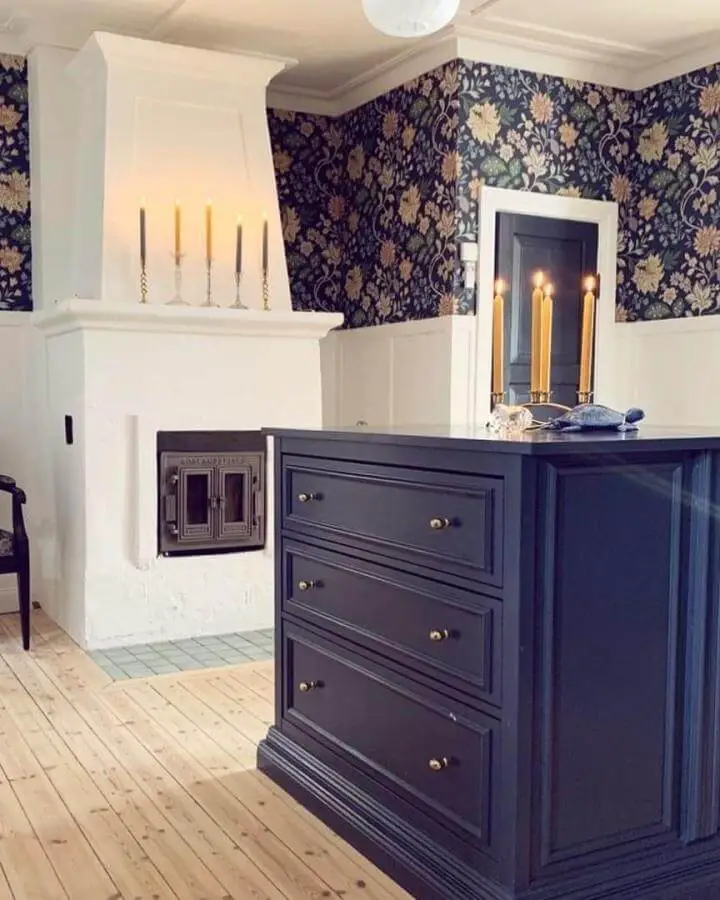 Dark blue wooden drawer unit with brass knobs from @malmrosvillan showing ikea hemnes hacks in a cozy living space.