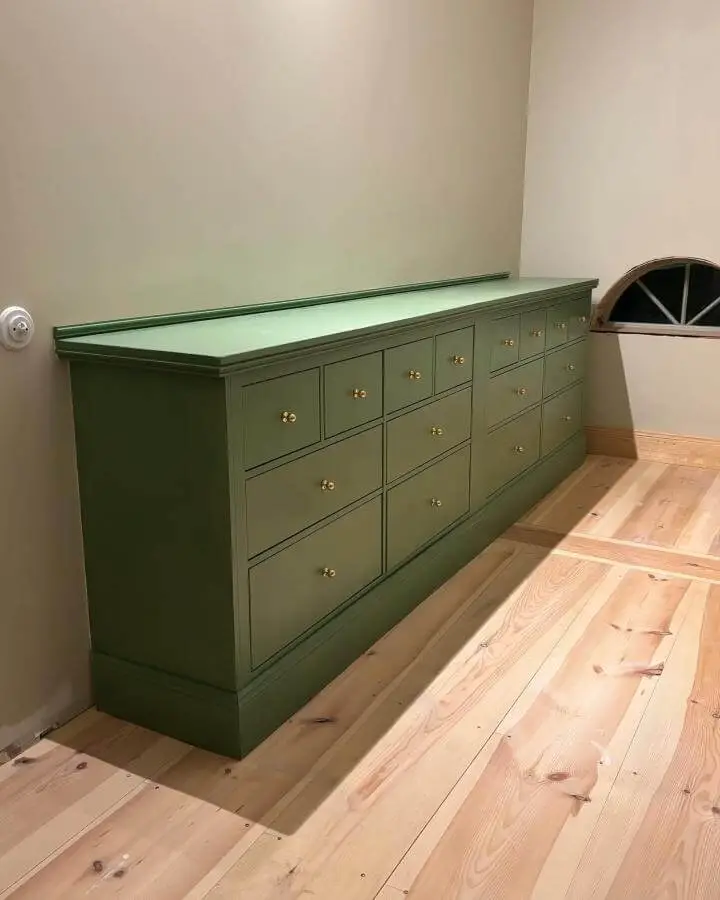 Olive green painted Ikea Hemnes chest with brass knobs and custom base molding from @flytt_av_ostergarden ikea hemnes hacks.