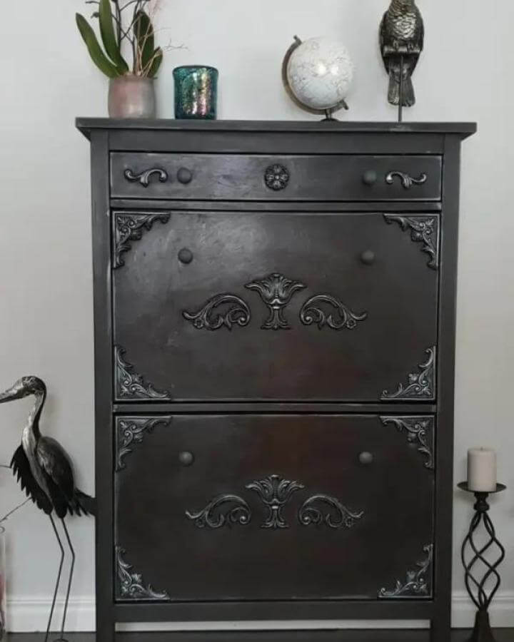 Black matte painted Ikea Hemnes dresser with ornate decorative appliques in a gothic style from Ikeahackers.