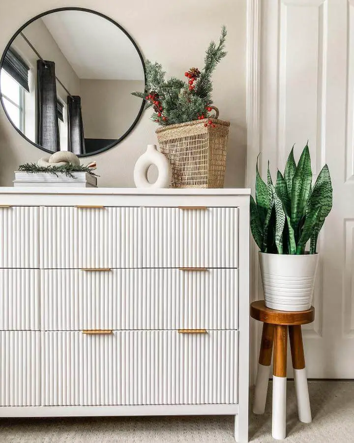 White ribbed textured Ikea Hemnes dresser with gold handles in cozy living space from @xomyhome. Elegant modern style makeover.