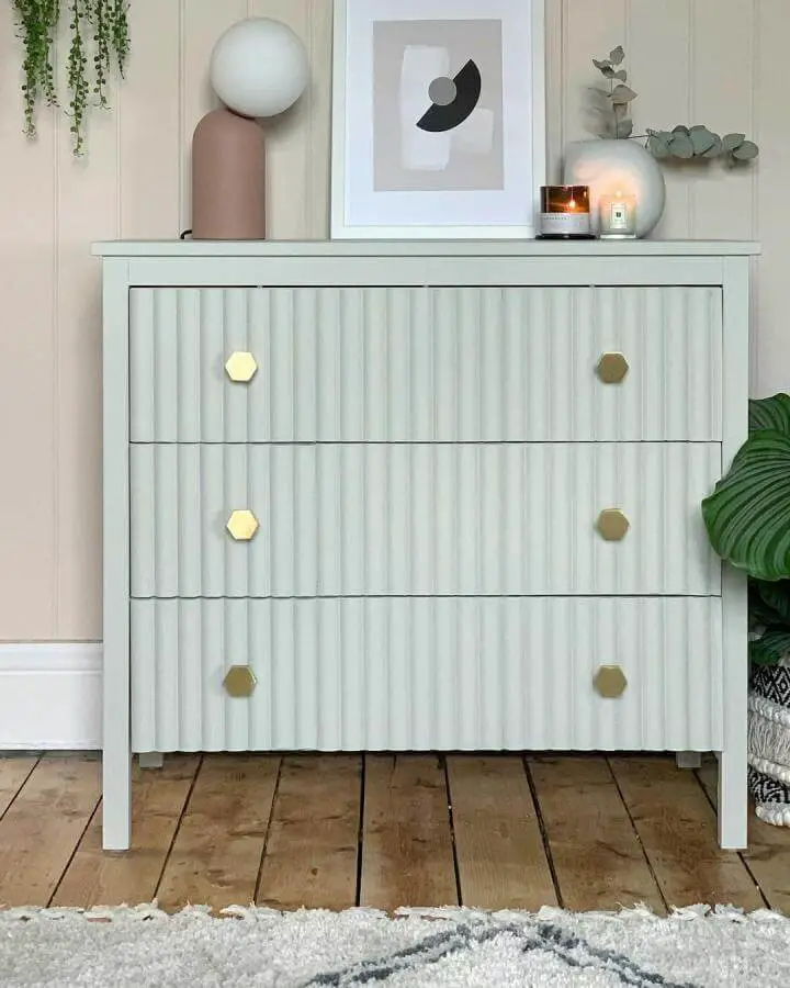 Light grey ribbed drawer fronts with brass hexagonal knobs on Ikea Hemnes chest by @crack_the_shutters showcasing unique ikea hemnes hacks.