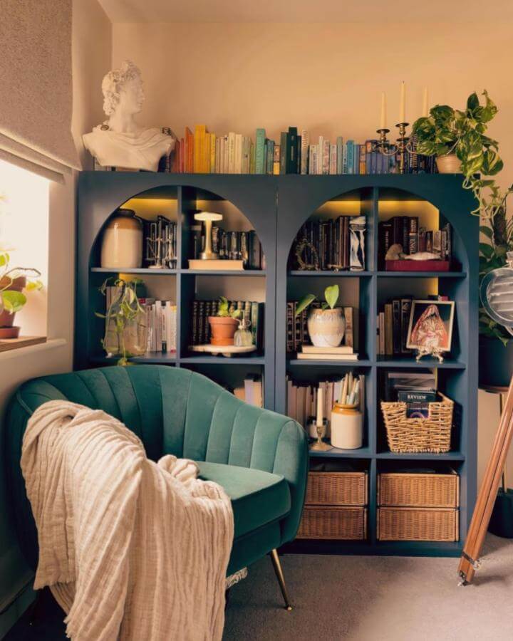 deep teal arched ikea kallax hacks & ideas shelving unit from @handmadehome_durham with warm lighting and wicker baskets