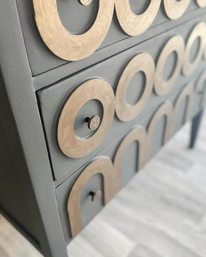Gold and gray painted Ikea Koppang chest with circular drawer accents and black knobs from @sageandvintage.