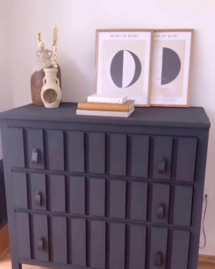 Matte black Ikea Koppang dresser with vertical slats and leather strap handles from @theflippedpiece. Modern minimalist style.