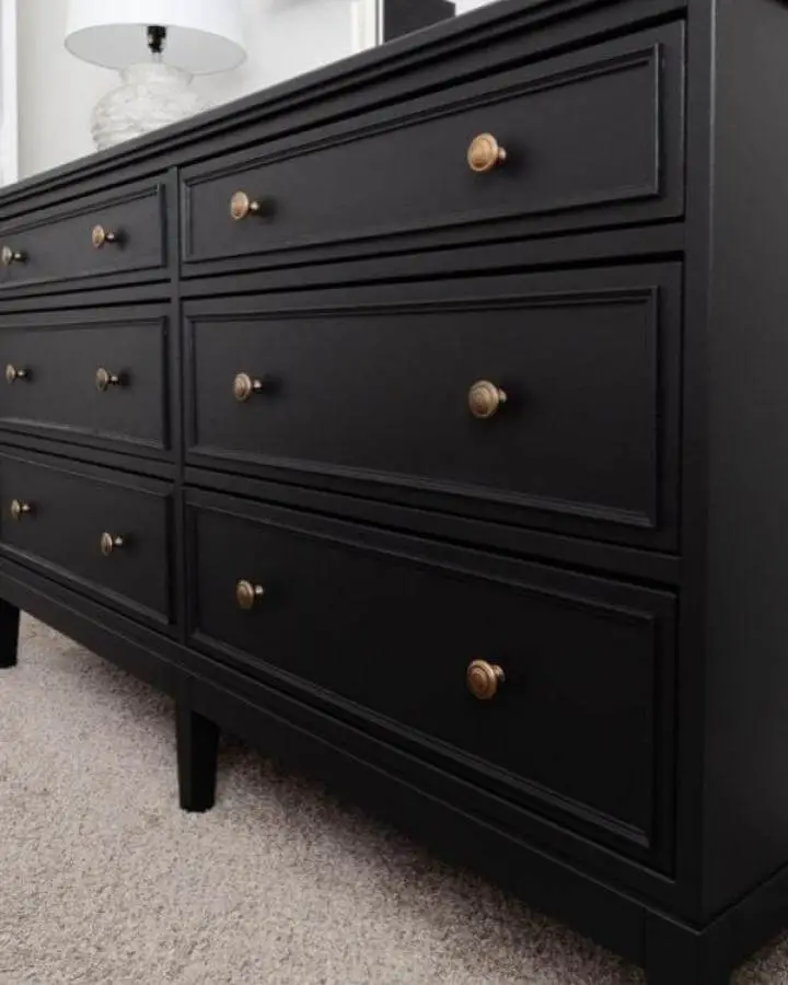 Black Ikea Koppang hacks dresser with brass knobs and molding detail from Jessica Belteau, sleek and modern style.