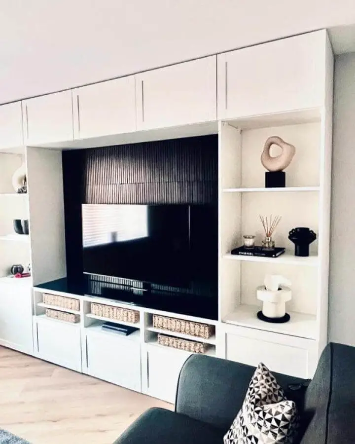 white media center with woven baskets and textured black back panel from @our_persimmon_hatfield_plot132 ikea media center hacks & ideas with decorative shelves and clean lines