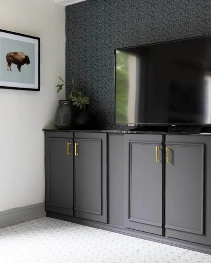 Dark gray matte painted media center with brass handles and patterned wallpaper from @georgestownonmymind. ikea media center hacks & ideas.