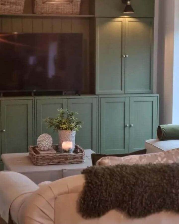 sage green built-in cabinets in cozy living room from @the_coopers_home showing ikea media center hacks & ideas with warm natural elements