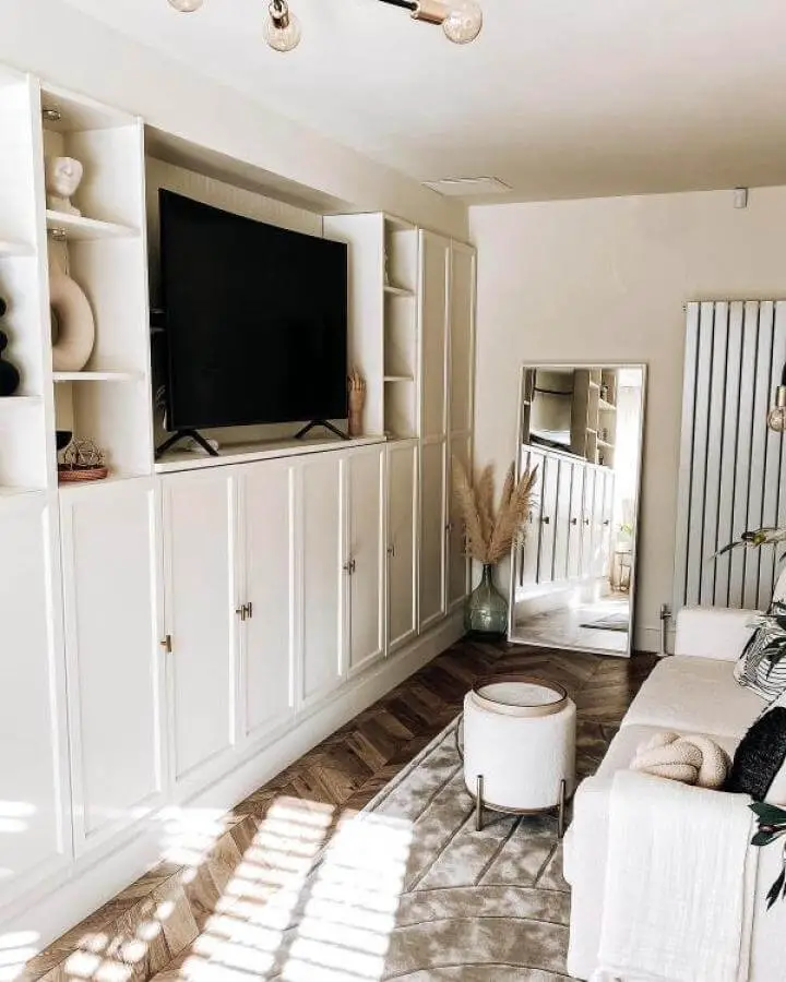 White panel door media center with open shelves and brass knobs from @thisblackgateshome showcasing ikea media center hacks & ideas in a bright living room.