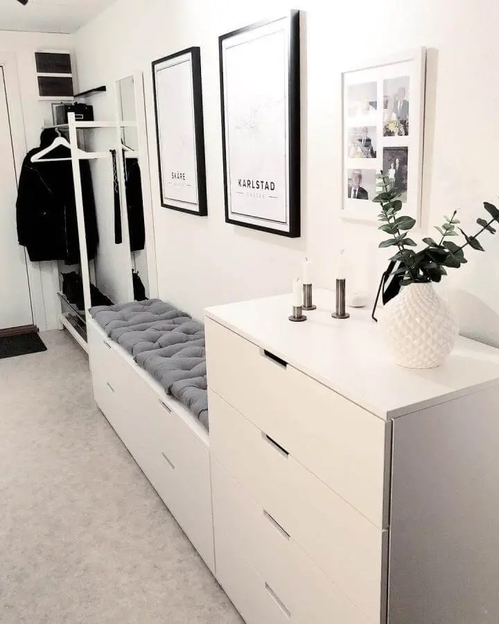 White minimalist drawer bench with gray tufted cushion and storage in a hallway from @elinshome ikea nordli hacks.