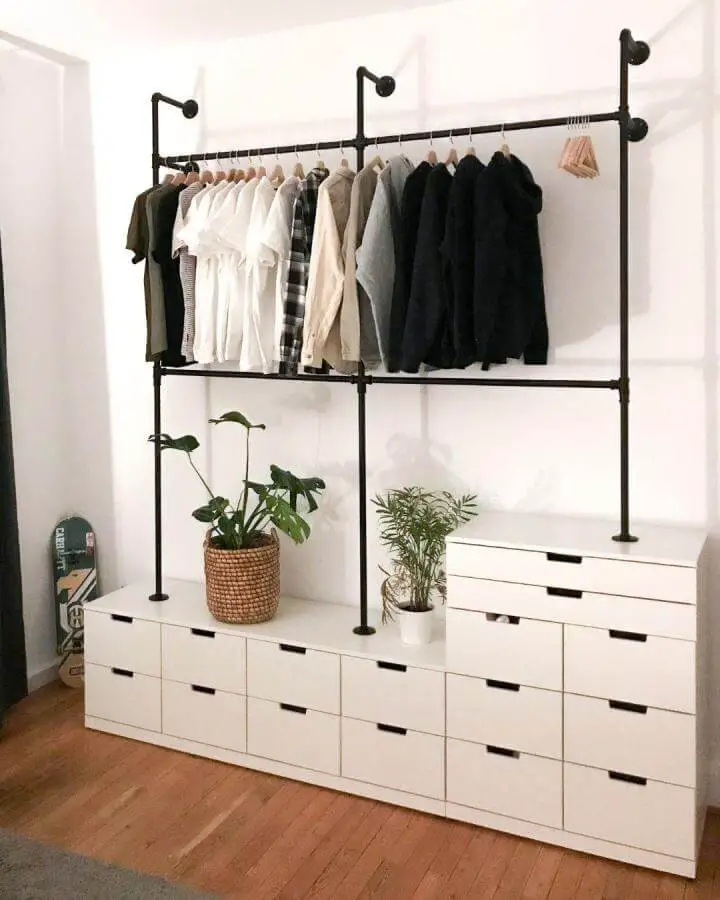 White minimalist ikea nordli hacks dresser with black industrial pipe clothing rack and plants by @pamo.design in a bright room.
