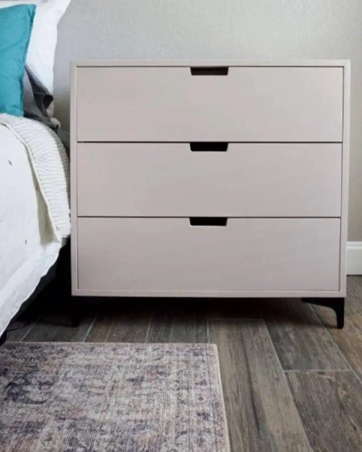 beige minimalist Ikea Nordli nightstand with black legs from Elle and Jay. Clean lines and modern handles.