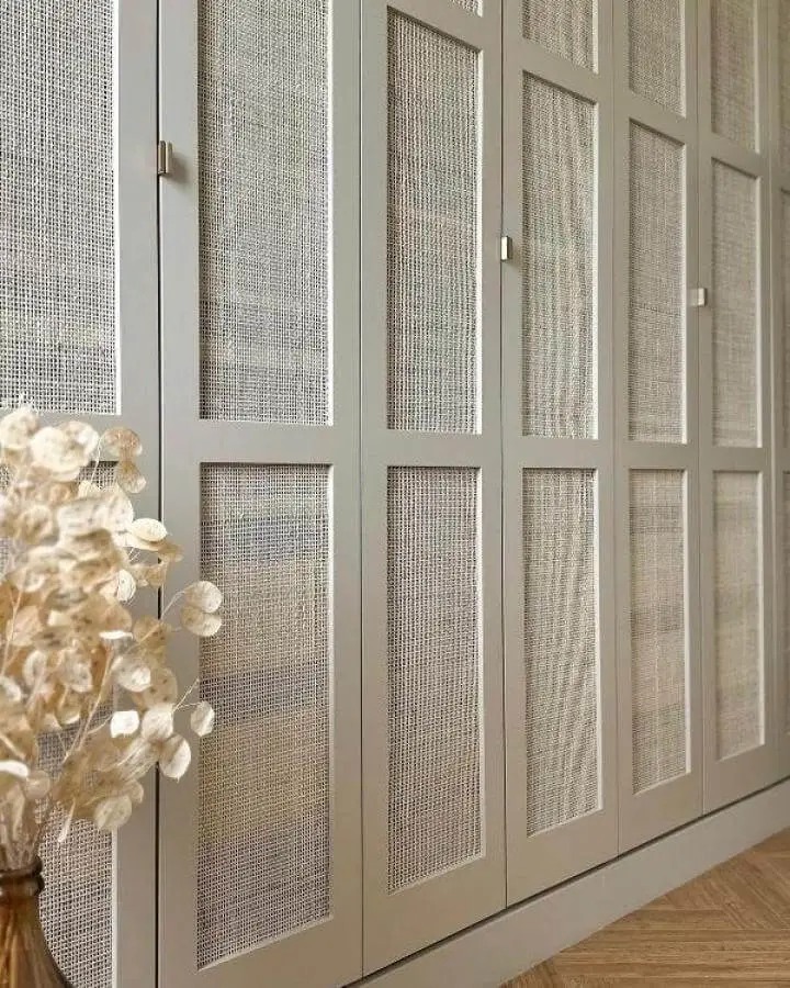 Light taupe Ikea Pax wardrobe doors with woven cane panels from @iaorana_house adding airy texture and warmth.