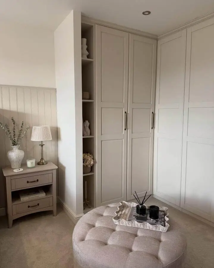 Beige paneled corner wardrobes with open shelves and brass handles from @lifeatlongtongrange. Cozy bedroom ikea pax hacks setup.