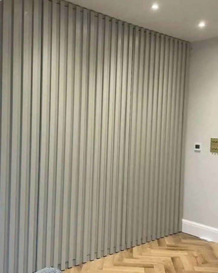 Light grey vertical panel sliding doors for Ikea pax hacks in modern room by @1930s_semirenovation. Clean and space-saving design.