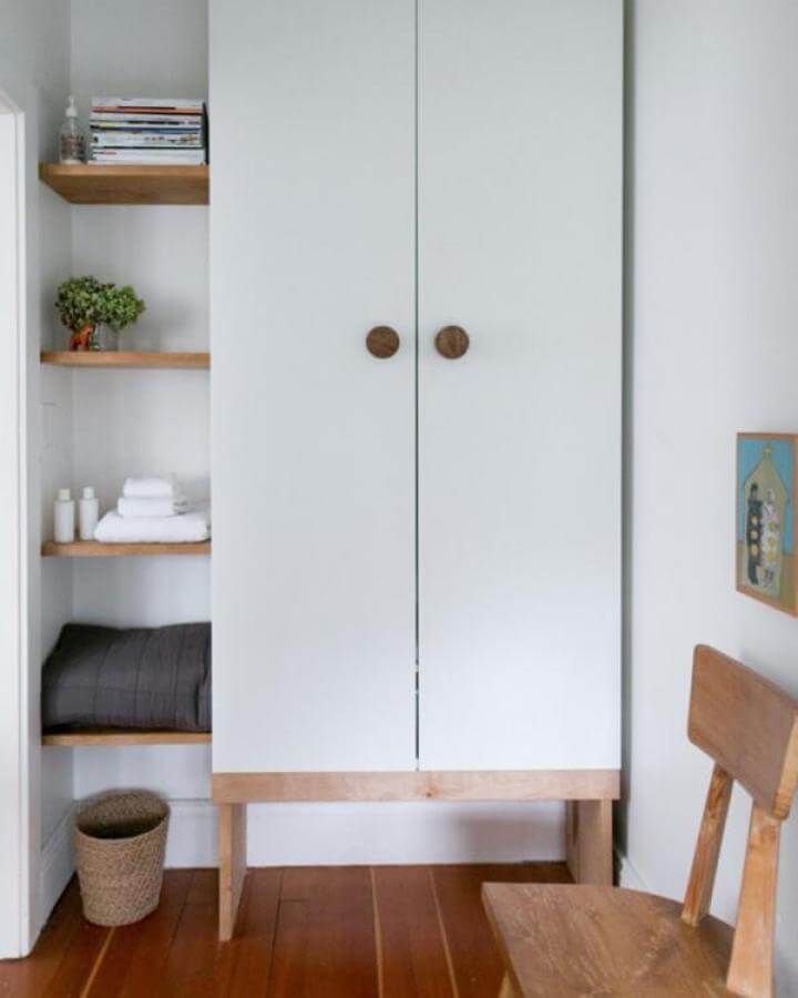 White and wood mid century style ikea pax hacks wardrobe with open shelves and wooden knobs Design Sponge inspiration.