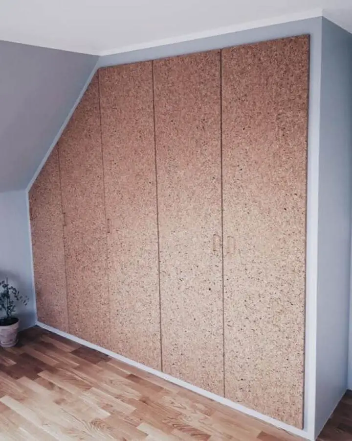 Natural cork door panels on Ikea Pax closet from Forstadsdromme. Custom fit for sloped ceiling with subtle handles.