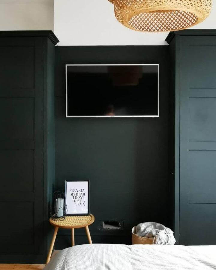 Matte black Ikea pax hacks bedroom wardrobes with rattan stool and basket from @number_twentyseven. Modern moody style.