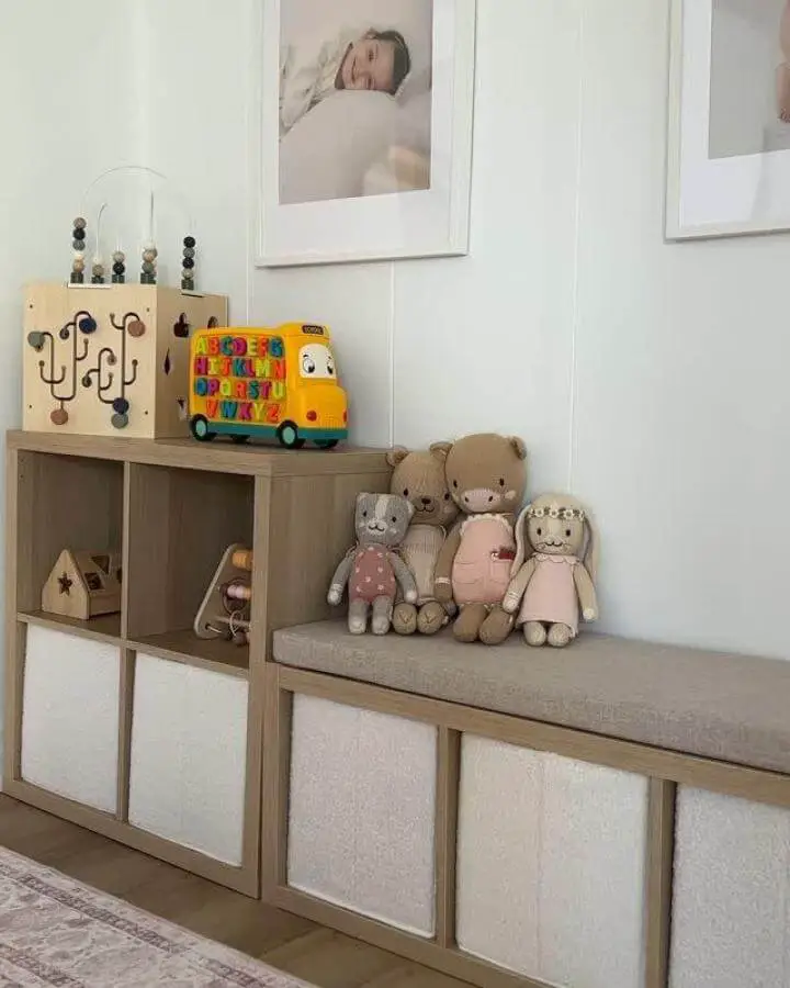 Light wood cube storage with cushioned bench and soft fabric bins in playroom from @stylewithgigi showcasing ikea playroom storage hacks & ideas.
