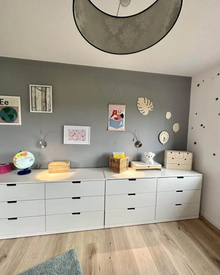 White modular drawer units against gray wall in child’s room from @abenteuer.kindsein for ikea playroom storage hacks & ideas with playful wall accents and light wood floor