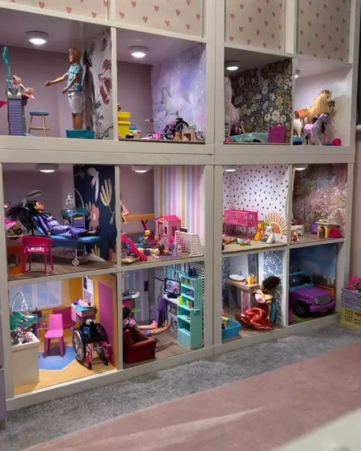 white modular shelving with mini room play setups from @thehumphreysdreams. Creative ikea playroom storage hacks & ideas with custom wallpaper and lighting.