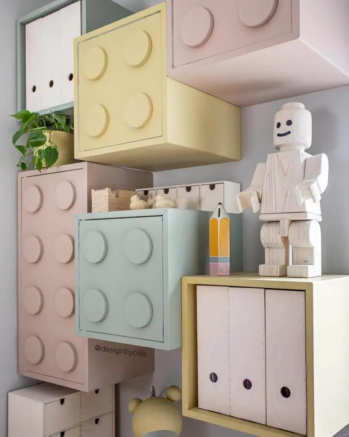 Pastel painted Lego-inspired storage cubes with circular studs mounted on wall for ikea playroom storage hacks & ideas.