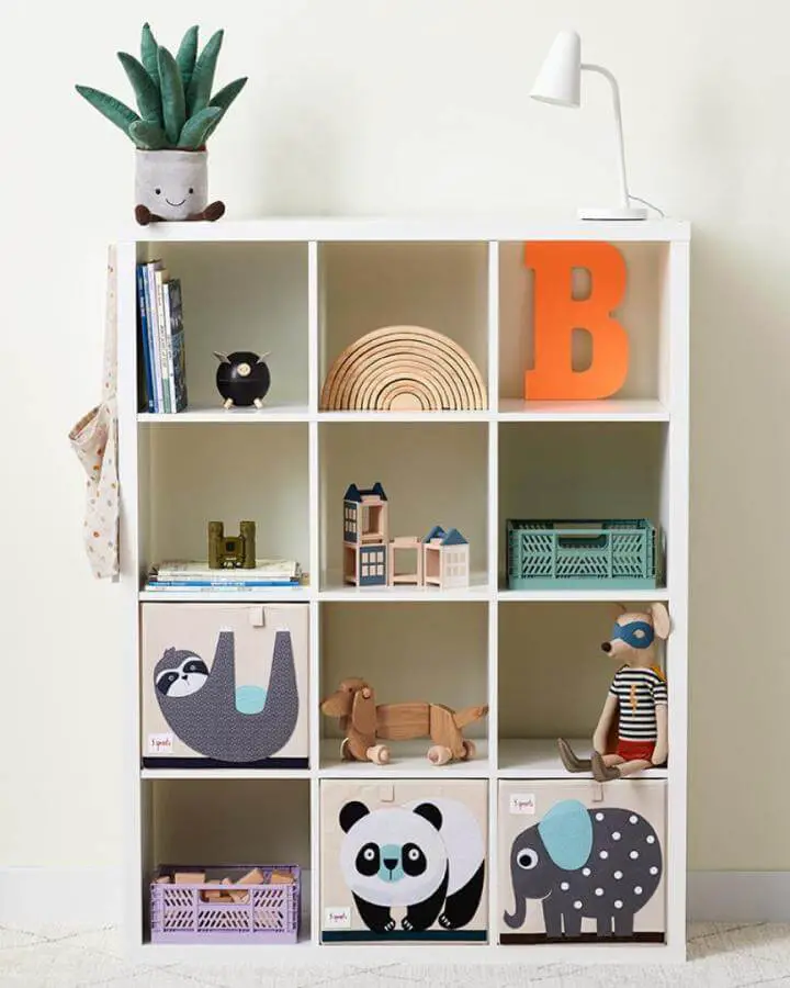 white cubed shelving with animal fabric bins and wooden toys for ikea playroom storage hacks & ideas from @3_sprouts bright and organized kid’s space