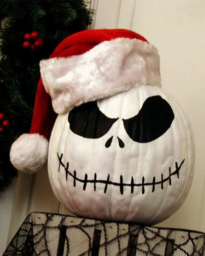 Painted jack skellington pumpkin from @lynleessweetlife. Features red Santa hat with white fur trim and black facial details.