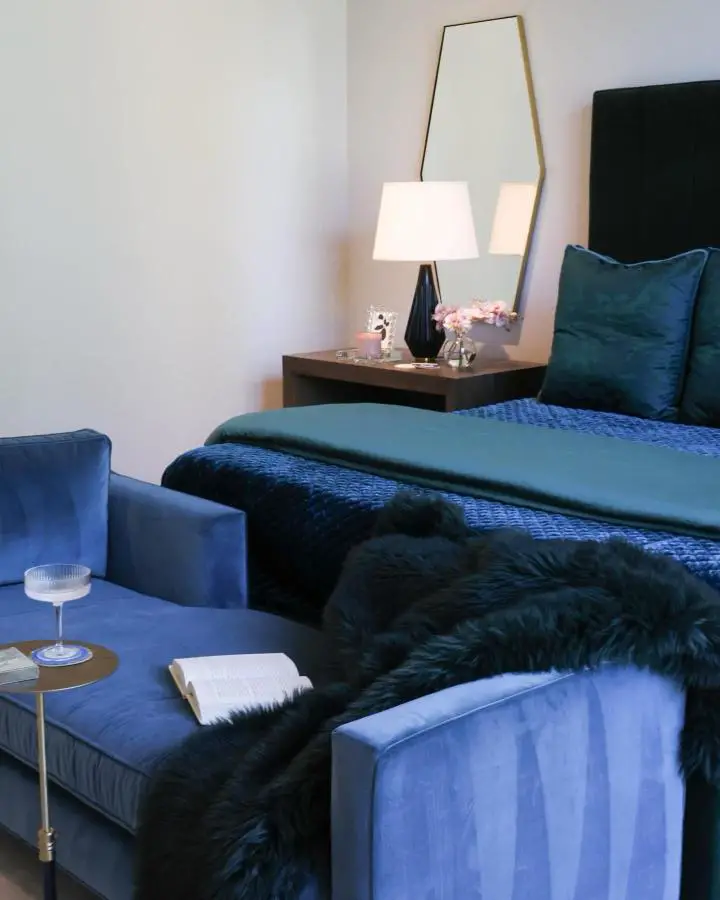 Deep blue velvet bedroom setup from @lemonhousekc showing luxurious jewel tone bedroom ideas with layered textures.