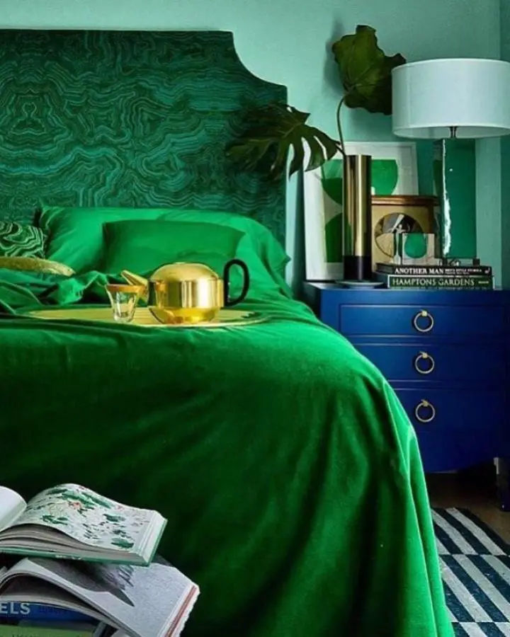 Emerald green malachite headboard from @mccaffreydesigngroup showcasing dramatic jewel tone bedroom ideas with royal blue nightstand accents.