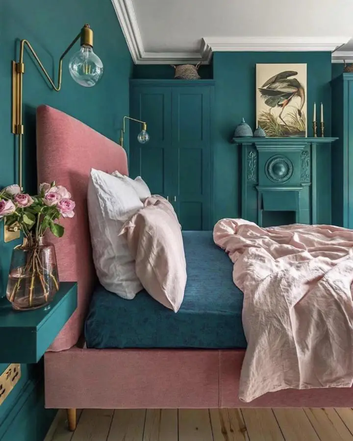 Emerald bedroom from @threeboysandapinkbathQQ showcasing pink velvet headboard jewel tone bedroom ideas with brass lighting accents.