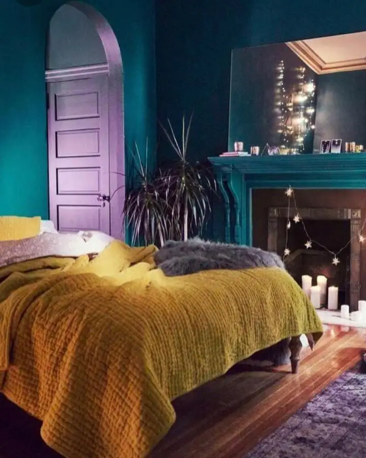 Dramatic teal bedroom from @kate_aubrey_interiors. Mustard bedding and purple door create bold jewel-toned contrast.