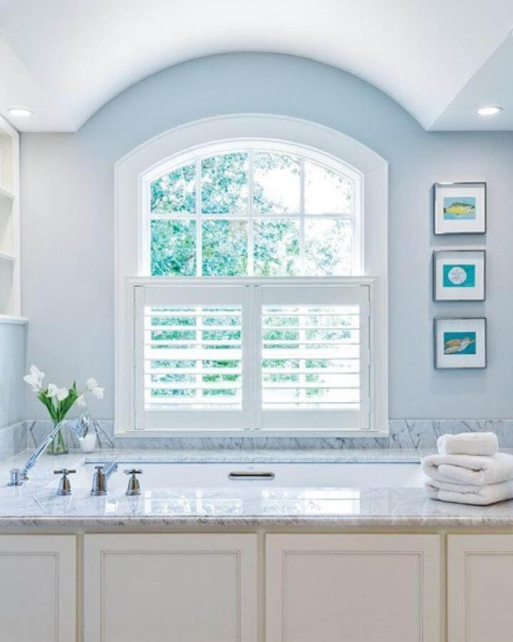 soft light blue bathroom with white shutters and marble countertop from @thecottagejournal bright and serene space with classic vibes