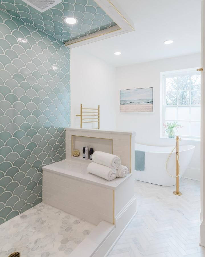Light blue fish scale tile bathroom wall and ceiling accents from @charleeneshouses with white marble and brass details creating light blue bathroom ideas.